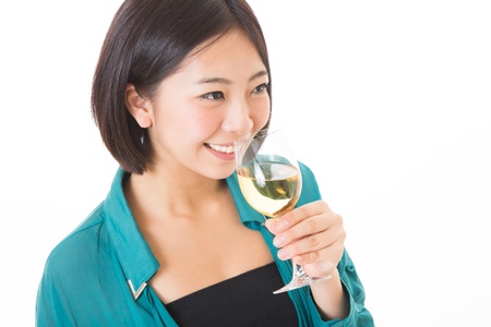 young attractive asian woman who drinks wineの写真素材