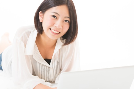 Young woman using a laptop computerの写真素材
