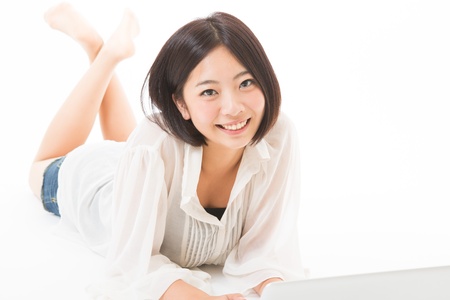 Young woman using a laptop computerの写真素材