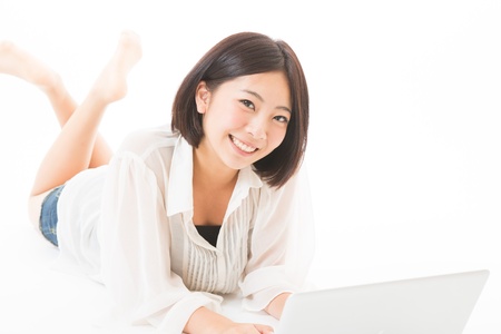 Young woman using a laptop computerの写真素材