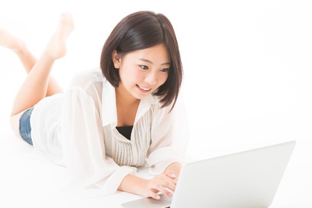 Young woman using a laptop computerの写真素材