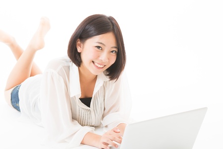 Young woman using a laptop computerの写真素材