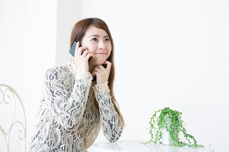 The young woman who talks on the telephoneの写真素材