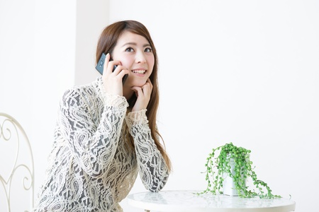 The young woman who talks on the telephoneの写真素材