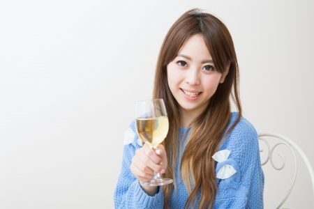 young attractive asian woman who drinks wineの写真素材