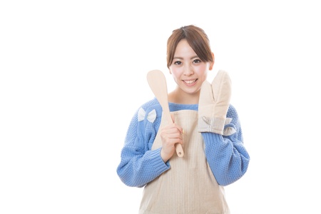 The woman who cooks with an apron figureの写真素材