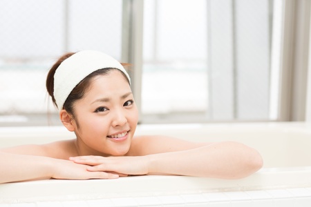 young woman who takes a bathの写真素材