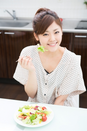 young attractive asian woman who  eatsの写真素材
