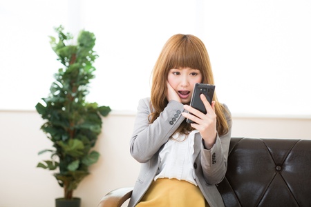 Beautiful young asian businesswoman using smart phoneの写真素材