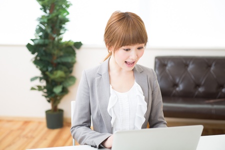 Beautiful young asian businesswoman using laptopの写真素材