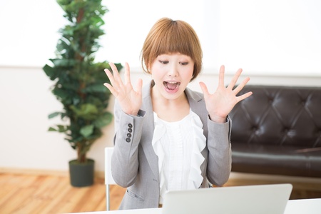 Beautiful young asian businesswoman using laptopの写真素材