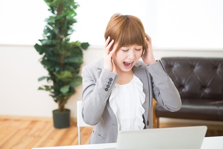 Beautiful young asian businesswoman using laptopの写真素材