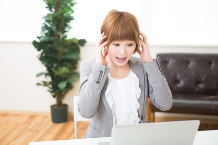 Beautiful young asian businesswoman using laptopの写真素材