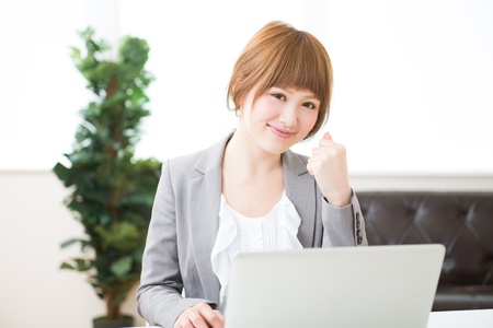 Beautiful young asian businesswoman using laptopの写真素材