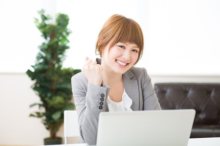 Beautiful young asian businesswoman using laptopの写真素材