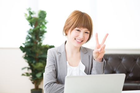 Beautiful young asian businesswoman using laptopの写真素材