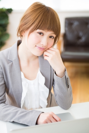 Beautiful young asian businesswoman using laptopの写真素材