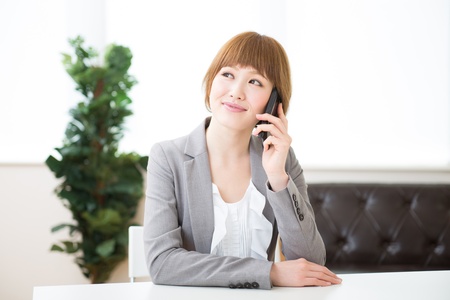 The Young businesswoman who talks on the telephoneの写真素材