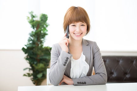 The Young businesswoman who talks on the telephoneの写真素材