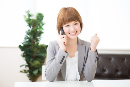 The Young businesswoman who talks on the telephoneの写真素材