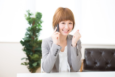 The Young businesswoman who talks on the telephoneの写真素材