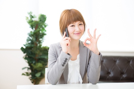 The Young businesswoman who talks on the telephoneの写真素材