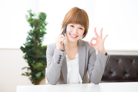 The Young businesswoman who talks on the telephoneの写真素材