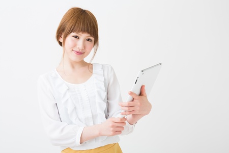 Beautiful young asian woman using tablet computerの写真素材