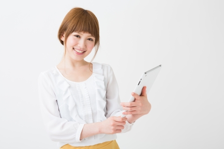 Beautiful young asian woman using tablet computerの写真素材