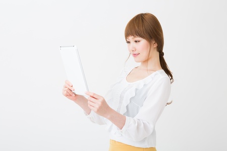 Beautiful young asian woman using tablet computerの写真素材