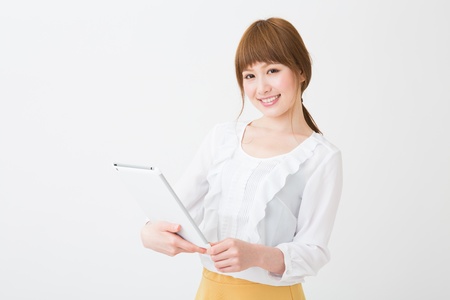 Beautiful young asian woman using tablet computerの写真素材