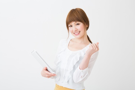 Beautiful young asian woman using tablet computerの写真素材