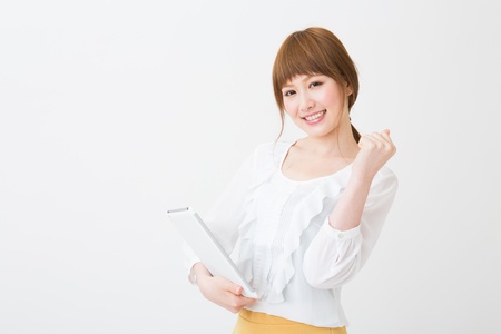 Beautiful young asian woman using tablet computerの写真素材