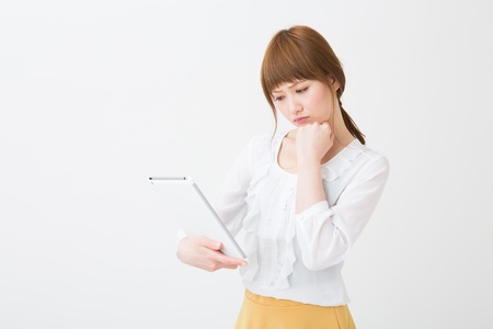 Beautiful young asian woman using tablet computerの写真素材