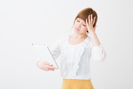 Beautiful young asian woman using tablet computerの写真素材