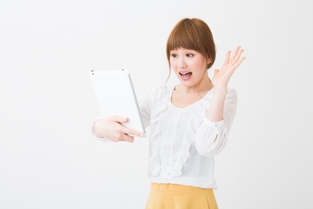 Beautiful young asian woman using tablet computerの写真素材