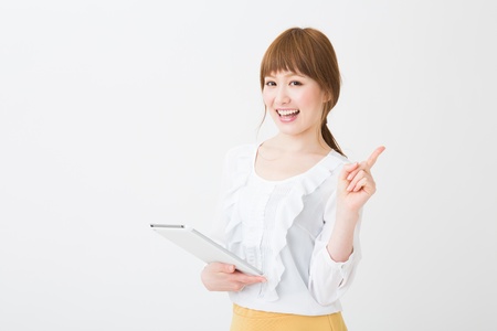 Beautiful young asian woman using tablet computerの写真素材