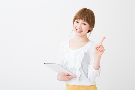 Beautiful young asian woman using tablet computerの写真素材