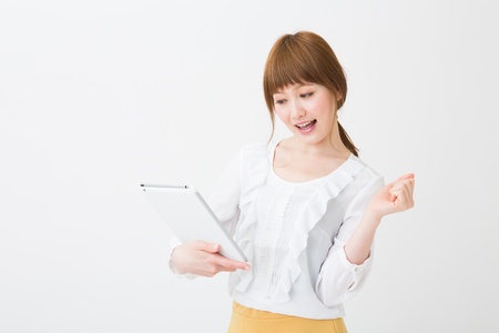 Beautiful young asian woman using tablet computerの写真素材