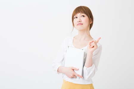 Beautiful young asian woman using tablet computerの写真素材