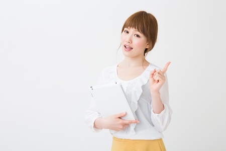 Beautiful young asian woman using tablet computerの写真素材
