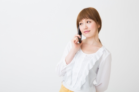 The Young businesswoman who talks on the telephoneの写真素材