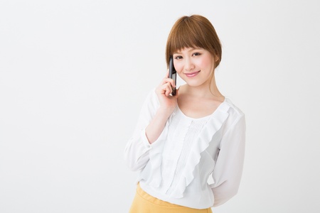 The Young businesswoman who talks on the telephoneの写真素材