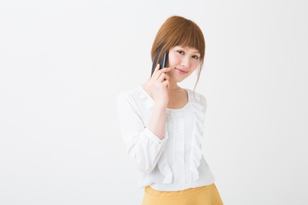 The Young businesswoman who talks on the telephoneの写真素材