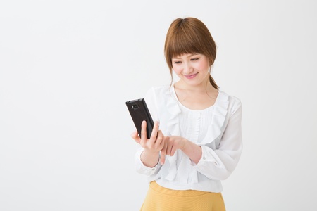 Young businesswoman to see a smart phoneの写真素材