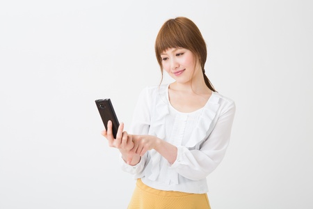 Young businesswoman to see a smart phoneの写真素材