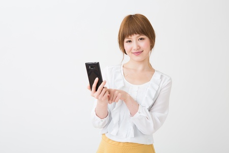 Young businesswoman to see a smart phoneの写真素材
