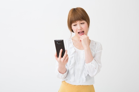 Beautiful young asian woman using smart phoneの写真素材