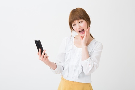 Beautiful young asian woman using smart phoneの写真素材