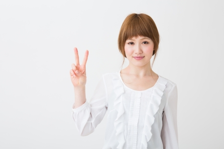 young attractive asian woman indicating the number twoの写真素材